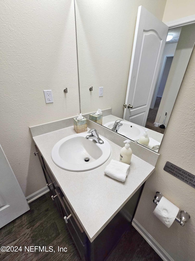 bathroom with vanity and hardwood / wood-style floors