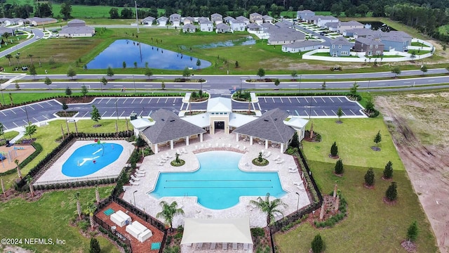 view of swimming pool with a patio area and a water view