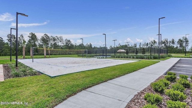 view of property's community featuring a lawn and volleyball court