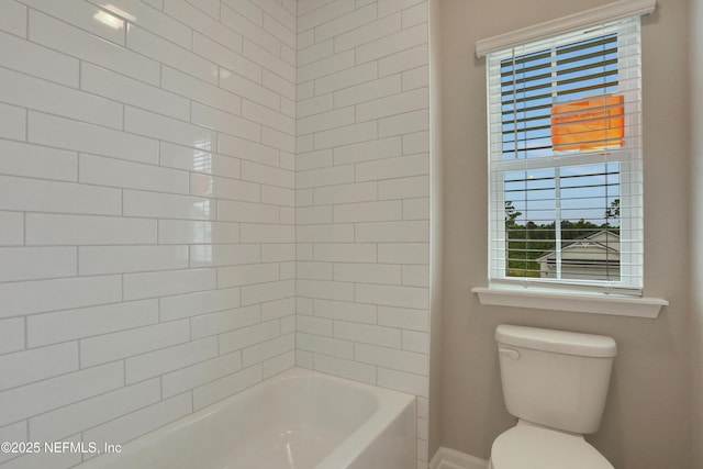 bathroom with plenty of natural light, bathtub / shower combination, and toilet