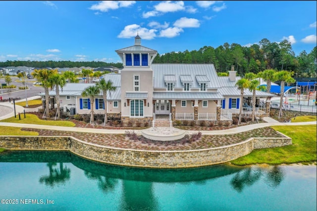 rear view of property with a standing seam roof, metal roof, a chimney, and french doors