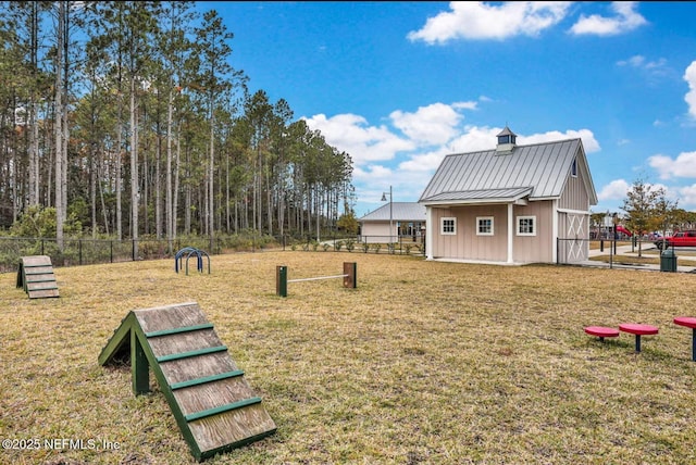 view of community with a yard and fence