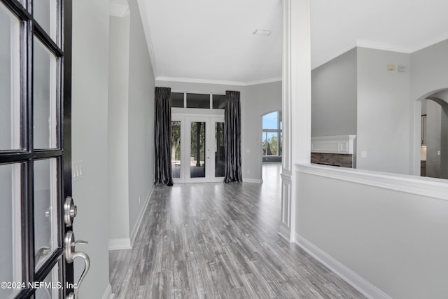 entrance foyer with crown molding and light hardwood / wood-style flooring