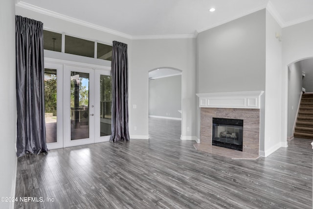 unfurnished living room featuring french doors, dark hardwood / wood-style floors, and crown molding