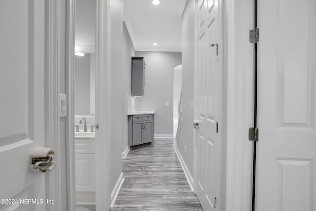 hall featuring light hardwood / wood-style floors and sink