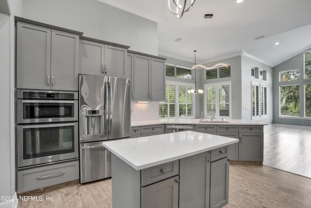 kitchen with gray cabinetry, stainless steel appliances, and plenty of natural light