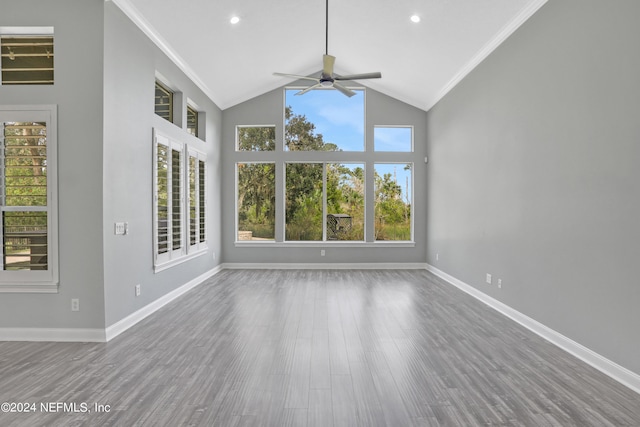 unfurnished living room featuring ceiling fan, high vaulted ceiling, ornamental molding, and hardwood / wood-style floors