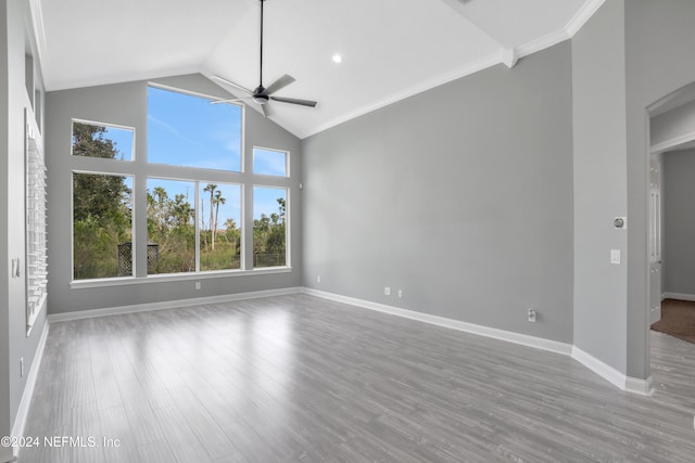 empty room featuring ornamental molding, a healthy amount of sunlight, hardwood / wood-style flooring, and ceiling fan