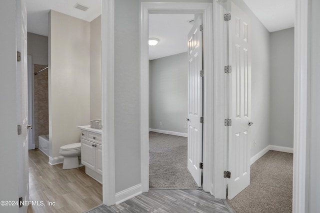 full bathroom featuring vanity, toilet, wood-type flooring, and bathing tub / shower combination