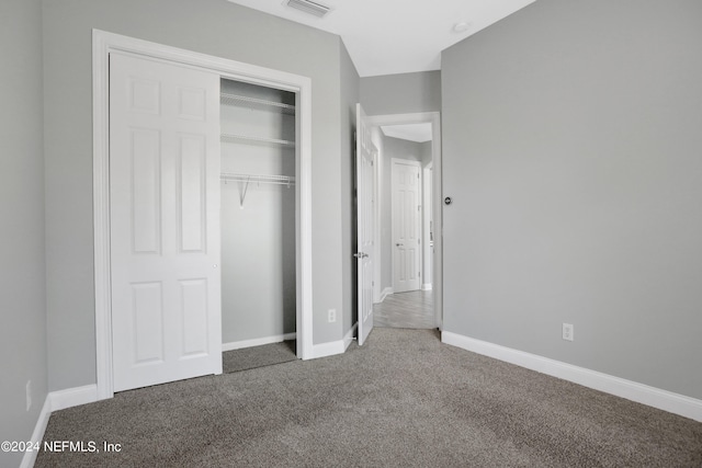 unfurnished bedroom featuring a closet and carpet flooring