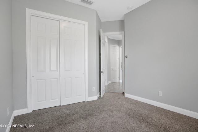 unfurnished bedroom featuring a closet and carpet