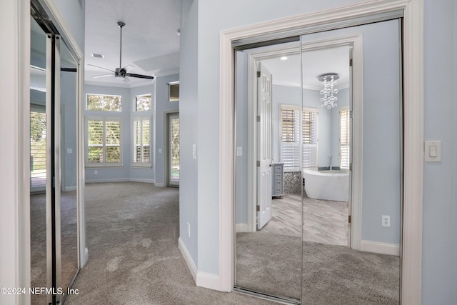 corridor featuring crown molding and carpet flooring