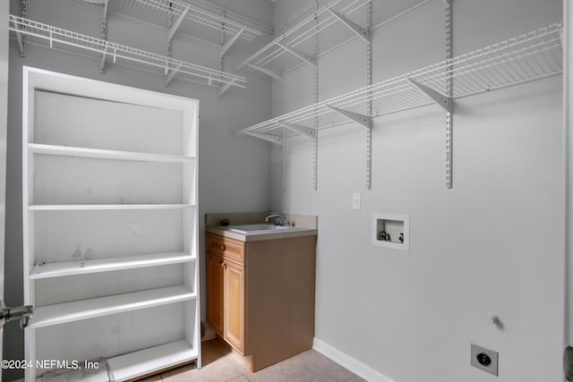 washroom featuring hookup for an electric dryer, sink, and washer hookup