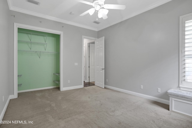 unfurnished bedroom with a closet, light carpet, ornamental molding, and ceiling fan