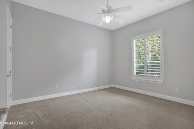 unfurnished room featuring light colored carpet and ceiling fan