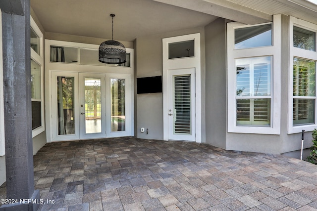 property entrance with a patio and french doors