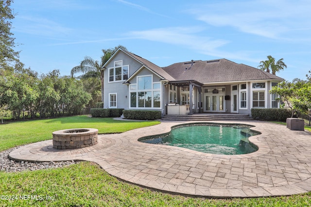 rear view of property with a yard, a patio, a fire pit, and ceiling fan