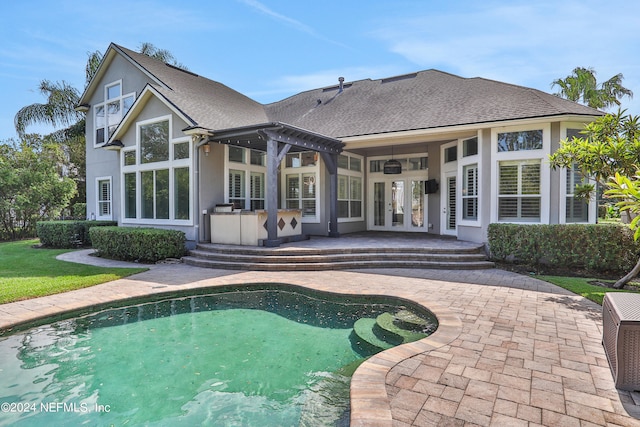 rear view of house with a patio, ceiling fan, and french doors