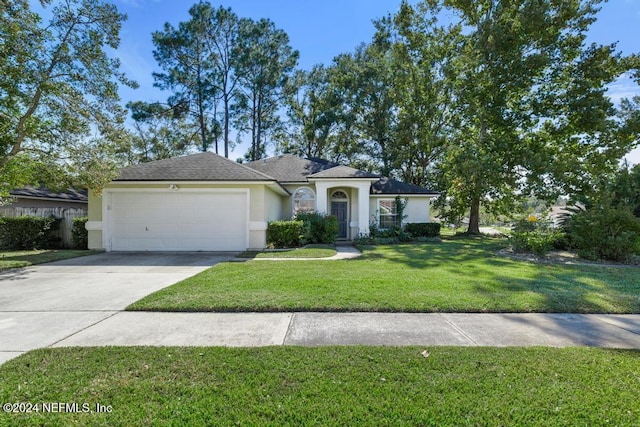 view of front of property featuring a front lawn and a garage