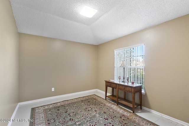 spare room featuring a textured ceiling