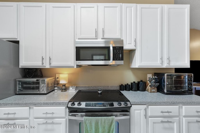 4021 Savannah Glen Blvd, Orange Park, FL 32073 - kitchen with white cabinets, light countertops, appliances with stainless steel finishes, and a toaster