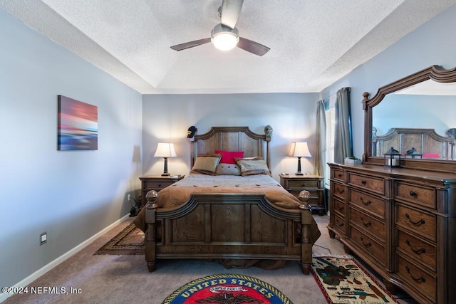 bedroom featuring light carpet, a textured ceiling, and ceiling fan