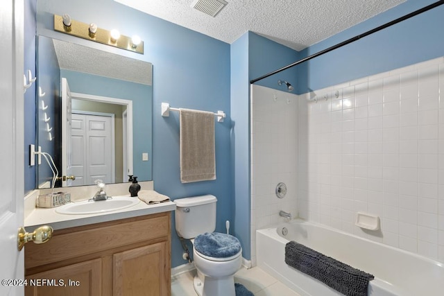 full bathroom with tiled shower / bath, a textured ceiling, toilet, vanity, and tile patterned floors