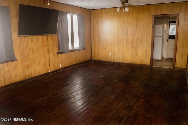 762 N Walnut St, Starke, FL 32091 - empty room featuring a ceiling fan, wood-type flooring, healthy amount of natural light, and wood walls