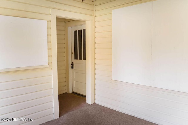 762 N Walnut St, Starke, FL 32091 - spare room with dark colored carpet and wood walls