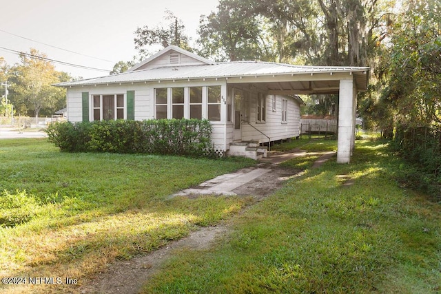 762 N Walnut St, Starke, FL 32091 - view of front of property featuring metal roof, entry steps, and a carport