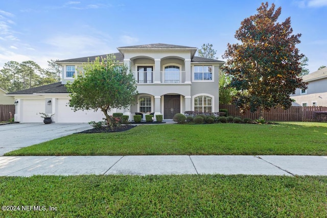 view of front of house featuring a balcony and a front lawn