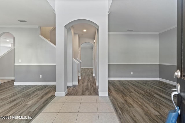 foyer with crown molding and wood-type flooring