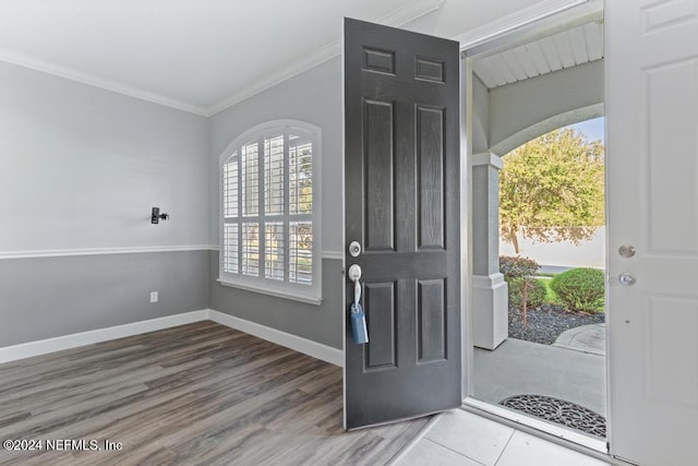 entrance foyer with crown molding and hardwood / wood-style flooring