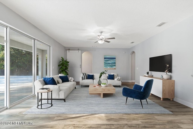 living room with ceiling fan and light hardwood / wood-style flooring