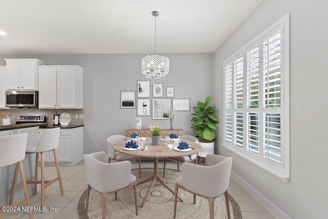 tiled dining area with a notable chandelier