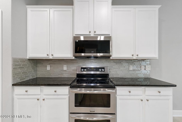 kitchen featuring appliances with stainless steel finishes, backsplash, and white cabinetry