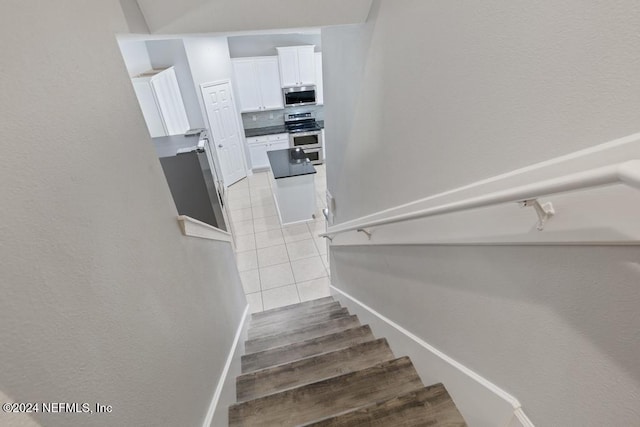 stairway featuring hardwood / wood-style flooring