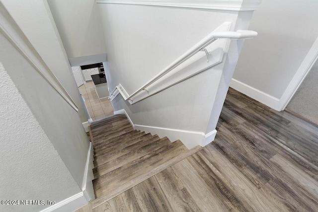 stairway with hardwood / wood-style floors