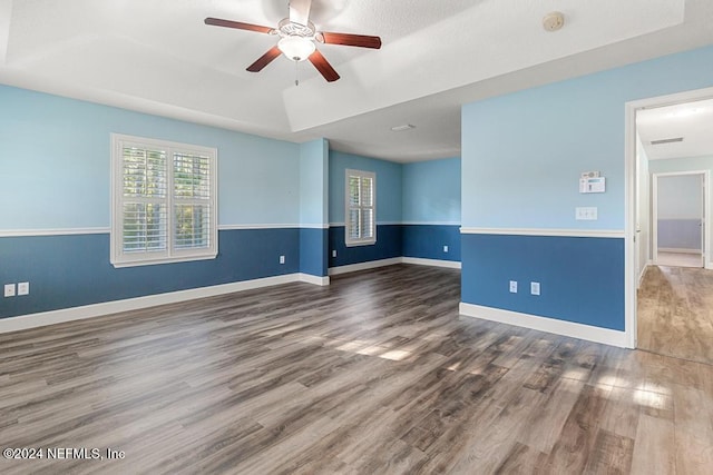 empty room featuring dark hardwood / wood-style floors and ceiling fan