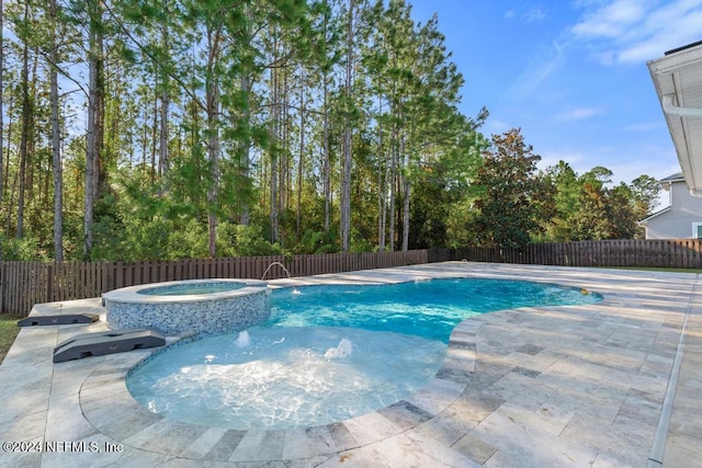 view of pool with an in ground hot tub and a patio area