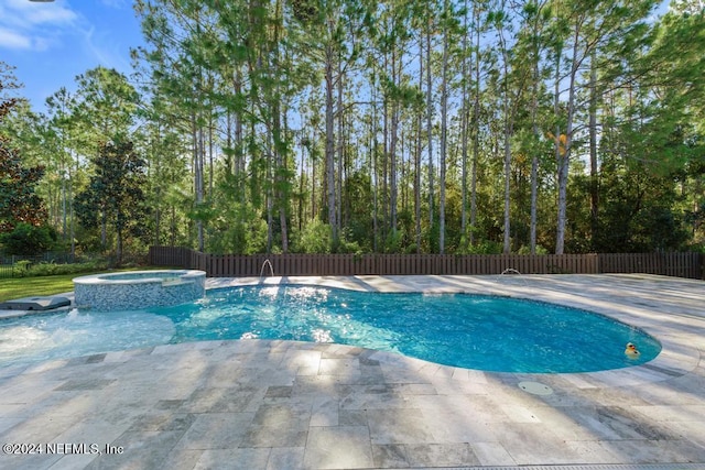 view of pool featuring an in ground hot tub and a patio