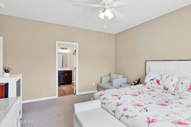 bedroom featuring ceiling fan, light carpet, and ensuite bath