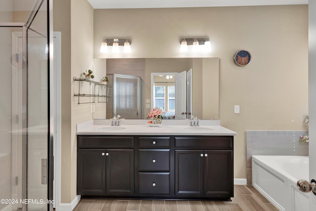 bathroom with vanity, separate shower and tub, and hardwood / wood-style floors