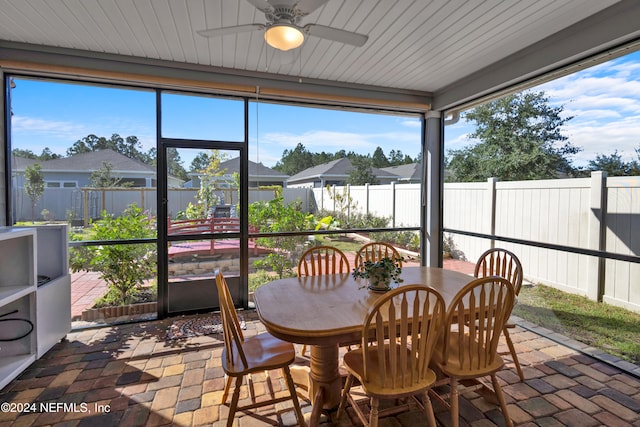 sunroom / solarium with ceiling fan and plenty of natural light