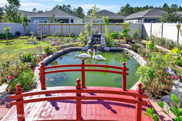 view of yard featuring a garden pond