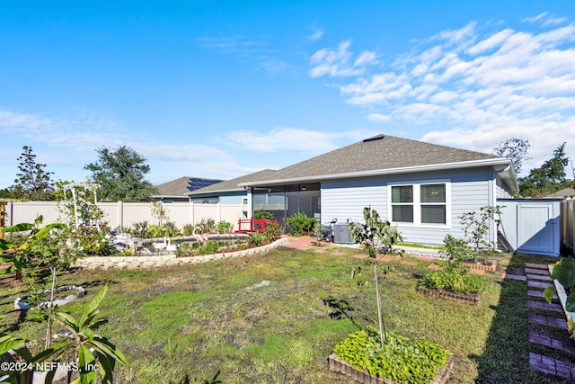 rear view of house featuring a shed