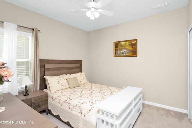 bedroom featuring light carpet and ceiling fan