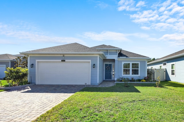 view of front of house with a garage and a front lawn