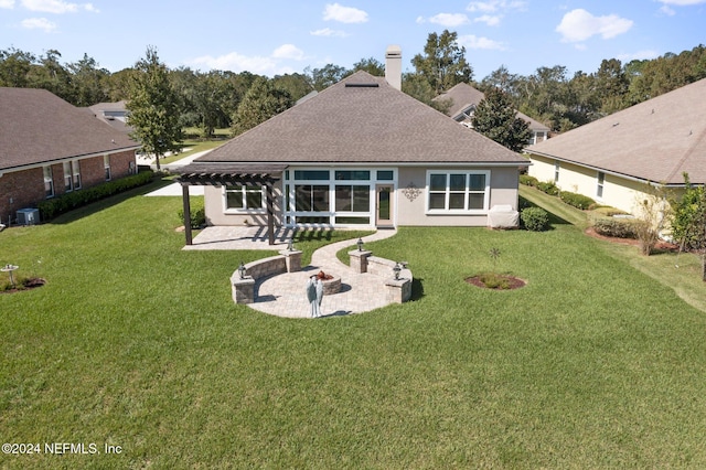 rear view of property featuring a patio area and a lawn