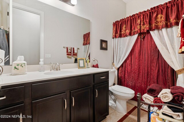 bathroom featuring vanity, toilet, and tile patterned floors